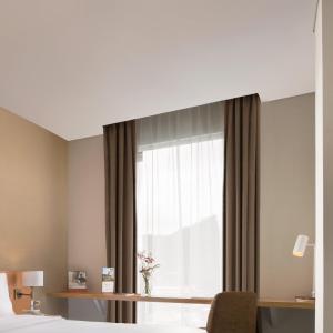 Postel nebo postele na pokoji v ubytování Swiss-Belinn Singkawang