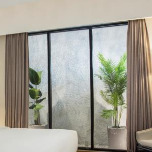 Postel nebo postele na pokoji v ubytování Swiss-Belinn Singkawang