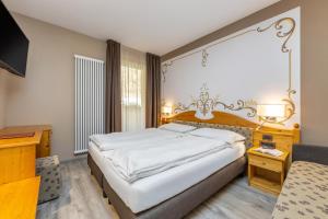 Postel nebo postele na pokoji v ubytování Hotel Vittoria - Ricarica l'anima