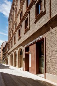 a large brick building on a city street at Sercotel Granada Suites in Granada