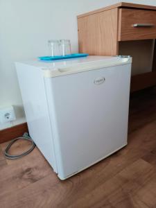 a white refrigerator with a plate on top of it at Hostal Miralva in Madrid