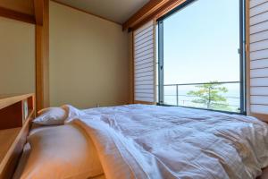 Uma cama ou camas num quarto em Oishiya