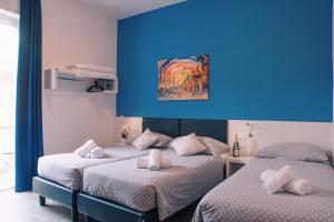Voodi või voodid majutusasutuse Hotel Aurora & Appartamenti toas