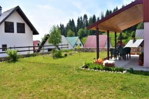 a house with a pavilion in a yard at Šepić Accommodation in Žabljak