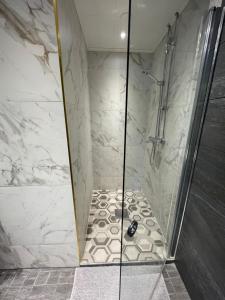 a bathroom with a shower with a glass door at Wherever Mini Hostel in Rovaniemi