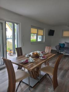 a dining room with a wooden table and chairs at Ferienhaus Natura 2000 in Steindorf am Ossiacher See +47 photos