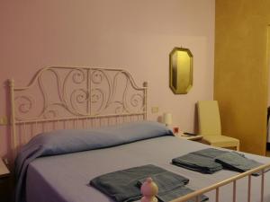 Posteľ alebo postele v izbe v ubytovaní Elisir b&b
