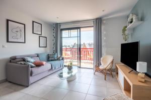 Televízia a/alebo spoločenská miestnosť v ubytovaní Appartement moderne pour 4 à deux pas de la plage