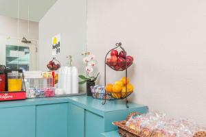 a counter with fruit in baskets on top of it at Days Inn by Wyndham San Francisco S/Oyster Point Airport in South San Francisco