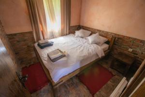 a bedroom with a bed with two boxes on it at Etno Selo Svodje in Vlasotince