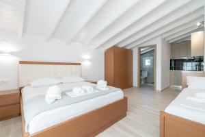 a bedroom with a large bed with towels on it at Art Studios in Neos Marmaras