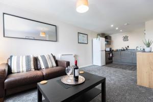 a living room with a couch and a table at Oakstays Gateshead in Gateshead