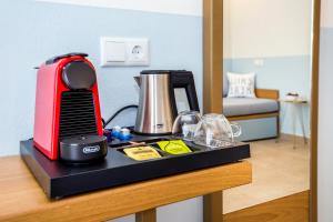 a counter with a coffee maker and a blender on it at Alia Comfort Style Studios in Limenaria