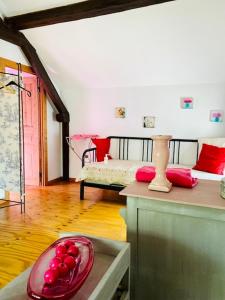 a room with a bed and a bowl of fruit on a table at Gîte Bucolique- Belle Epoque in Durbuy