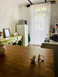 a pair of shoes sitting on a table in a kitchen at Gîte Bucolique- Belle Epoque in Durbuy