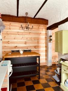 a kitchen with a checkered floor in a room at Gîte Bucolique- Belle Epoque in Durbuy