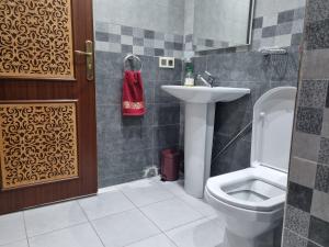 a bathroom with a toilet and a sink at New Luxury Apartment, 3 Bed, 7Mins to Beach - Aida in Tangier +20 photos