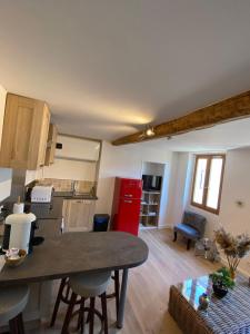 a kitchen and living room with a table and chairs at SOLEIL ZEN in Grasse