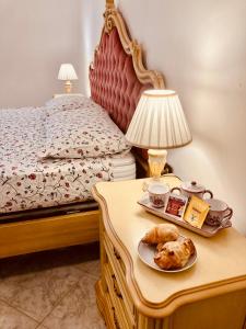 a bed with a table with a tray of food on it at Ai do fradei in Mestre