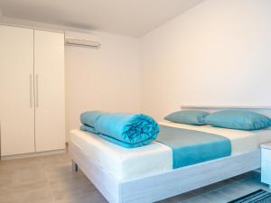 a bedroom with two beds with blue pillows on them at Luksuzna kuća za odmor "Villa Romantica" in Kraljevica +48 photos