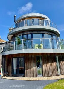 a large circular building with a round top at One of the best properties in Lyme! Breathtaking views across the whole bay. 3 stories with 2 tier veranda around the property. Sleeps 6 in Lyme Regis