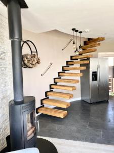 a spiral staircase in a house with a fireplace at One of the best properties in Lyme! Breathtaking views across the whole bay. 3 stories with 2 tier veranda around the property. Sleeps 6 in Lyme Regis