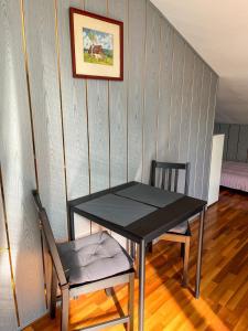 a black table and two chairs in a room at Cozy rooms in wine town - Modra in Modra