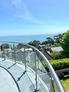 a metal railing on a balcony with a view of the ocean at One of the best properties in Lyme! Breathtaking views across the whole bay. 3 stories with 2 tier veranda around the property. Sleeps 6 in Lyme Regis