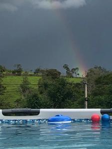 a pool with blue and red balls on the water at Cabaña Milan in San Gil