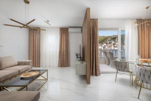 a living room with a couch and a table at Apartments Villa Maracella in Marina