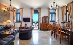 a living room with a couch and a table and chairs at Luxury Apartments Perko in Kaštela