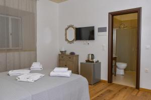 a bedroom with a bed with towels on it at Mansion Dasi in Spetses