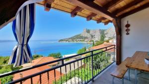 a balcony with a view of the ocean at Apartments Soric in Omiš