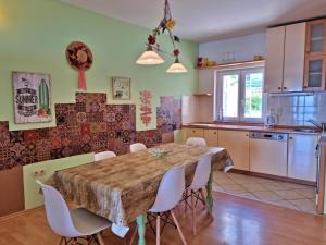 a kitchen and dining room with a wooden table and chairs at Apartments Soric in Omiš