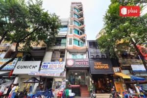 a building with signs on the side of a street at Saigon Pink Hotel in Ho Chi Minh City