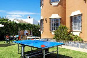 a ping pong table in front of a building at Villa Mirador Faro by Villa Plus in Mijas Costa