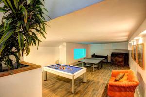 a room with a ping pong table in the middle of a room at Villa La Cala Playa by Villa Plus in La Cala de Mijas