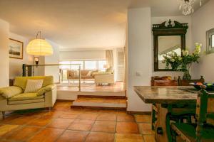 a living room with a couch and a table at Villa La Cala Playa by Villa Plus in La Cala de Mijas +27 photos