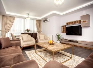 a living room with a couch and a tv at Gazioğlu Residence in Trabzon