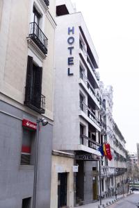 a building with a hotel sign on the side of it at Hotel Serrano in Madrid