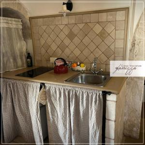 a kitchen with a sink and a counter top at Trullo Eliana in Alberobello