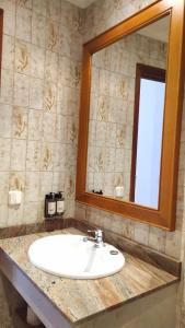 a bathroom with a white sink and a mirror at Hotel Nou Can Guillem in Cala Figuera