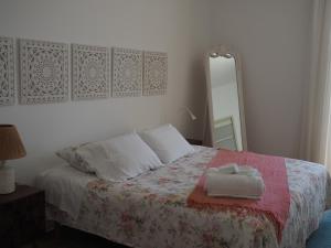 a bedroom with a white bedspread and white pillows at Formosa Guest House in Tavira