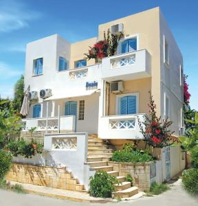 a white building with stairs in front of it at Renia Studios in Agia Pelagia