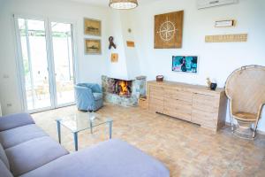 a living room with a couch and a fireplace at Relais Bellavista Tuscany in Suvereto