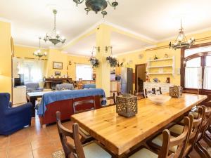 a dining room and living room with a wooden table at Casa alegría in Dúrcal