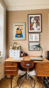 una oficina con un escritorio con una silla y pinturas en la pared en ApartmentInCopenhagen Apartment 1494, en Copenhague