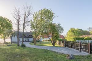 a house with a fence and a driveway at Haus am See in Torgelow am See