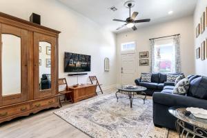 a living room with a blue couch and a tv at Renovated Historic 4BR House Near Magazine St & Uptown in New Orleans