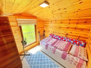a bedroom with a bed in a wooden room at ŞEN BUTİK OTEL ve BUNGALOV in Uzungol